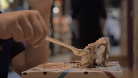 Boy-eating-ice-cream-dessert-in-shipping-mall-food-court