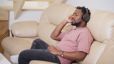 man listening to music on a couch