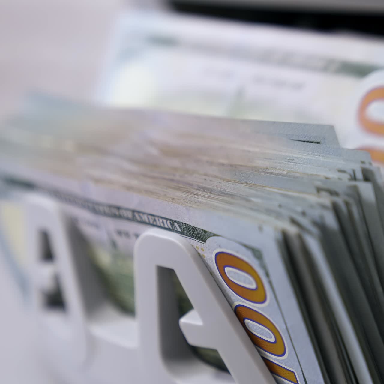 Automatic calculation of paper money. Detailed view of Us dollar banknotes on currency counter machine. Business economy of usa. Macro shot