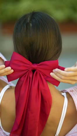 woman with a red bow in her hair