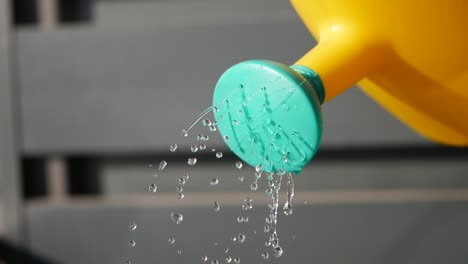 close up of a watering can pouring water