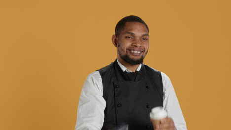 Professional-friendly-waiter-showing-the-pos-terminal-with-a-credit-card