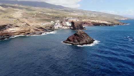 Roques-de-Fasnia,-Tenerife:-aerial-view-in-orbit-of-the-two-rock-formations-of-Fasnia-on-the-coast-of-Santa-Cruz-de-Tenerife-and-on-a-sunny-day