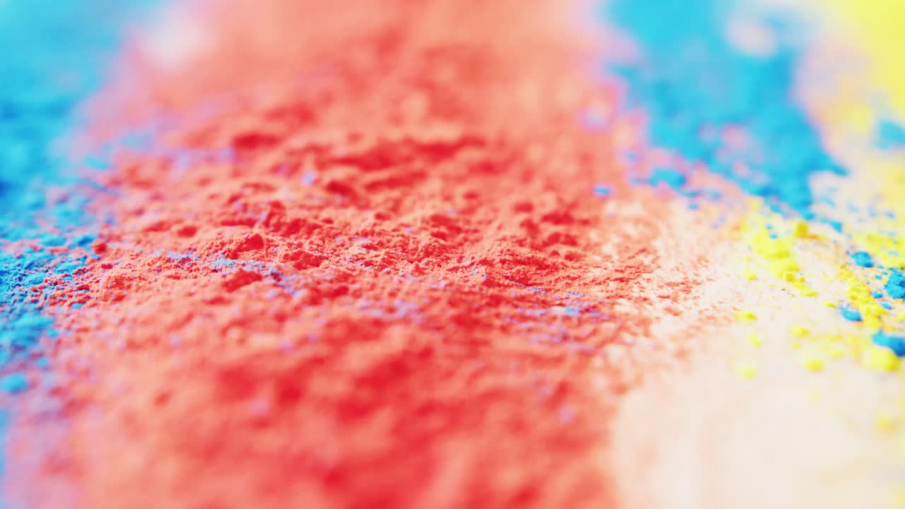 Video of close up of multi coloured powders with copy space on white background