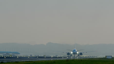 airplane taking off and taxiing at airport in foggy conditions