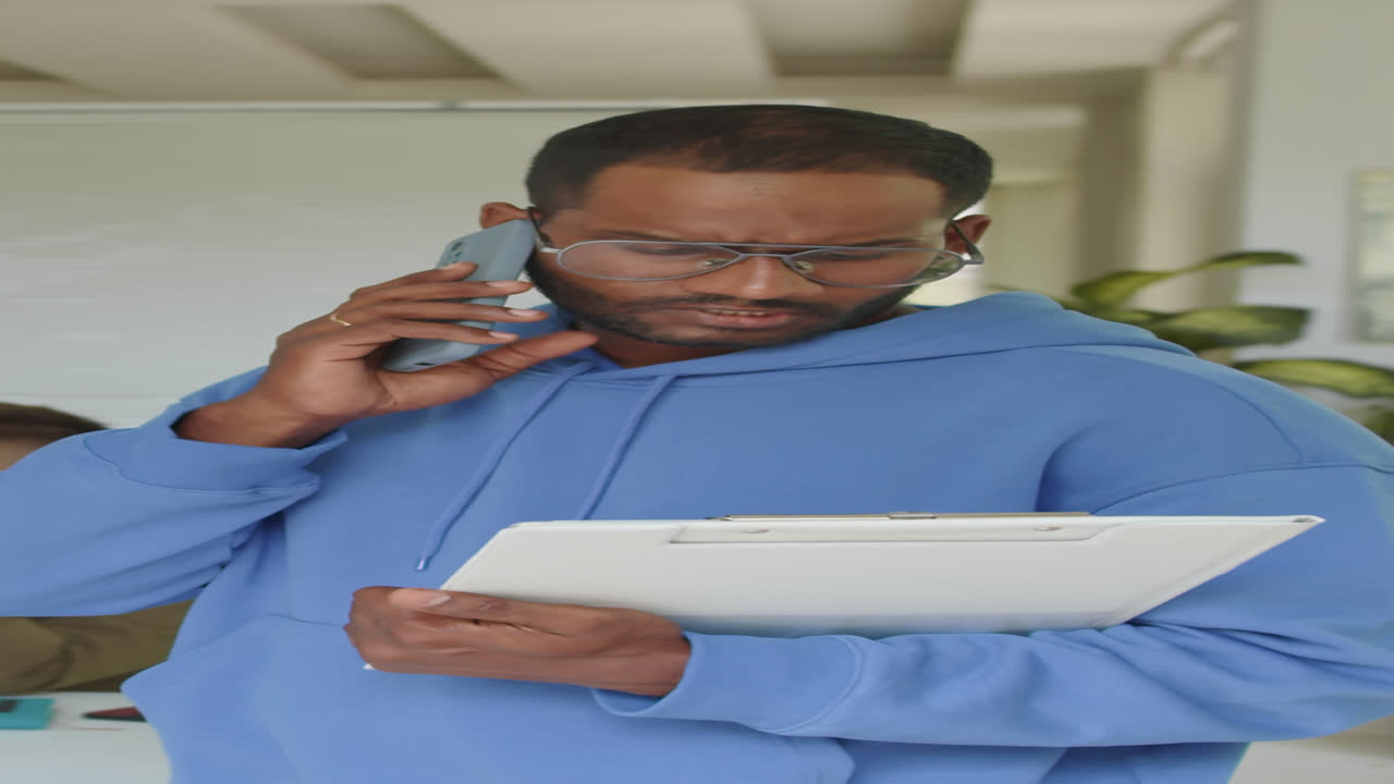 Vertical of Male Manager Consulting on Smartphone