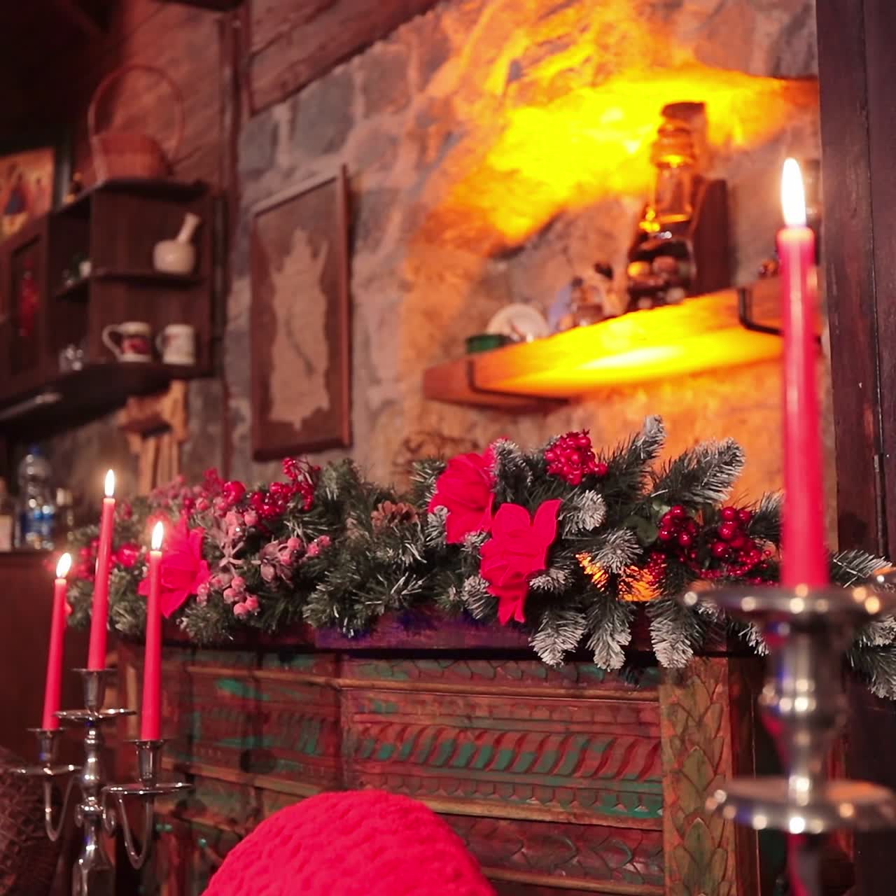 Wooden curved furniture in the living room with stone walls. Christmas decorations and dim light in the country house
