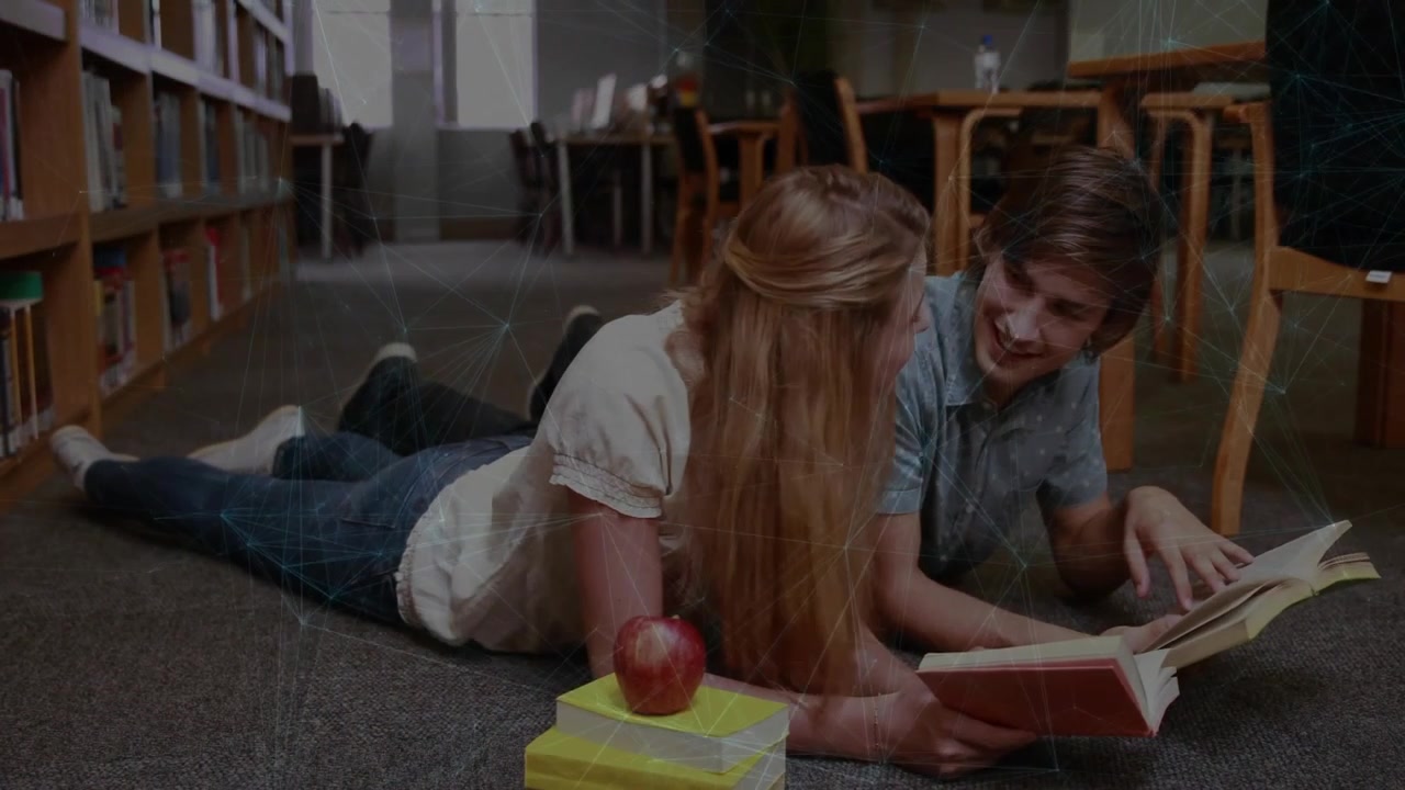 Two students in library studying book pages with highlight animating after finger tap for education