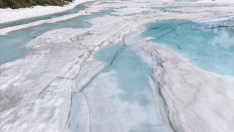 frozen lagazzuolo lake by snowy mountains in valmalenco, lombardy, italy