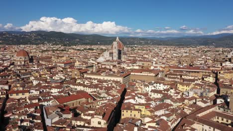 Aerial-panning-up-revealing-Cathedral-of-Santa-Maria-del-Fiore-and-city-on-a-sunny-day-in-Florence-in-Italy-in-4k