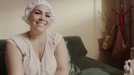 smiling woman adjusting a shower cap