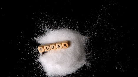 dice spelling out sugar falling in a pile of sugar