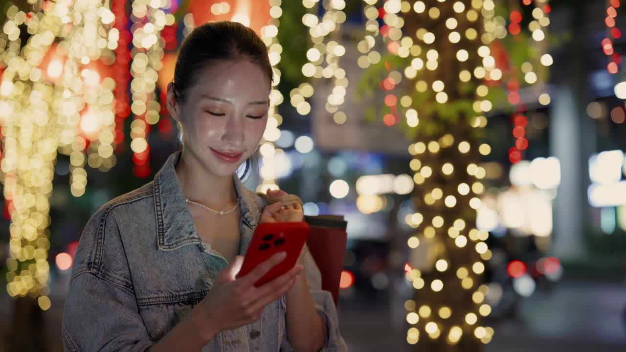 Woman using smartphone at night in a city