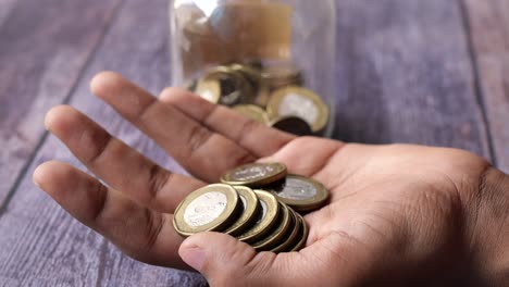 Close-up-of-man-hand-counting-coins-,