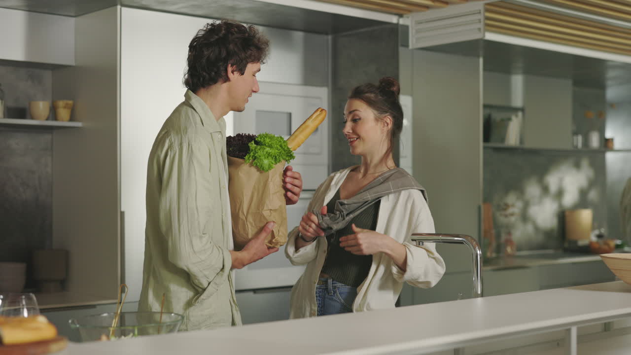 Couple in modern kitchen with groceries