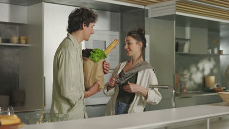 couple in modern kitchen with groceries