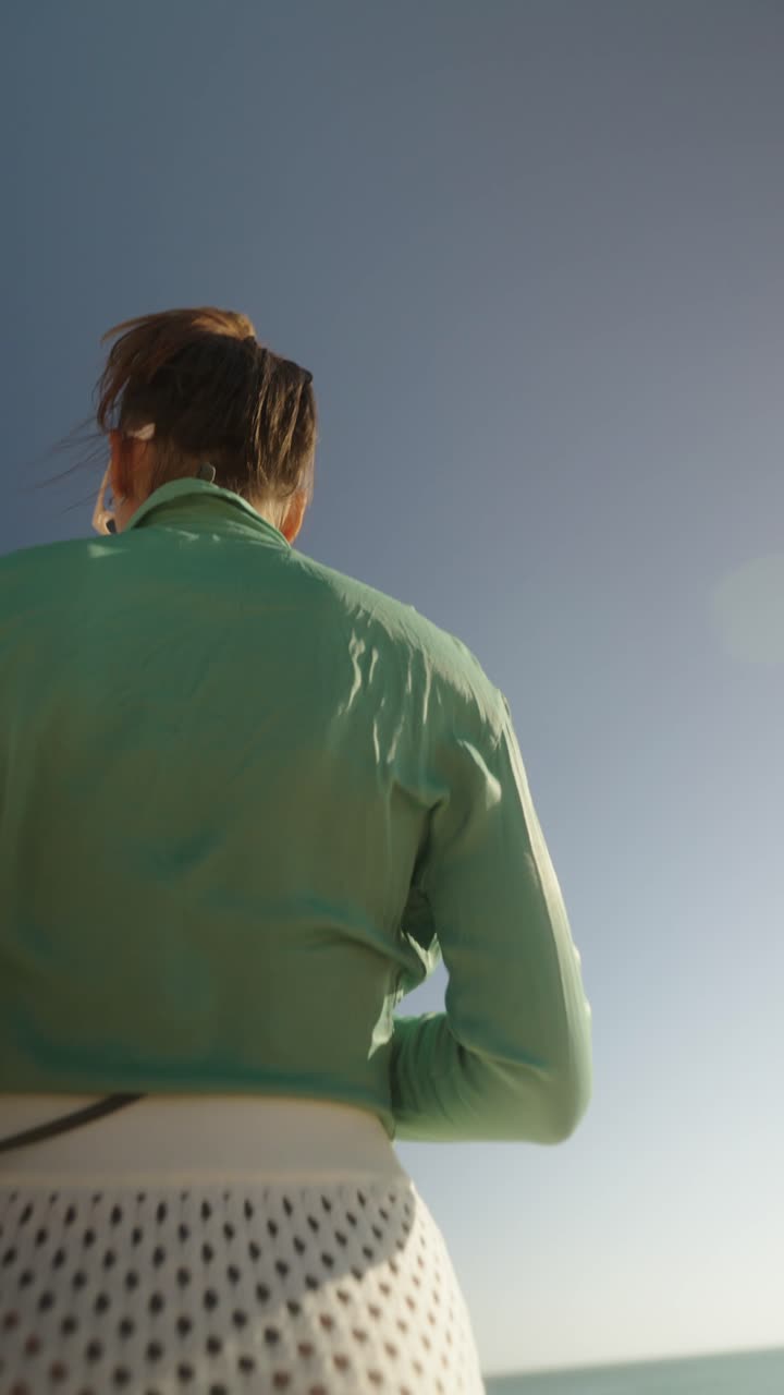 Woman in fashionable clothing on the beach