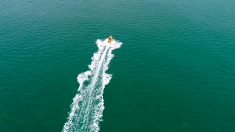 aerial follow of boat in ocean