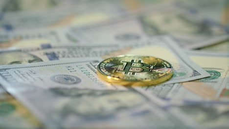 Cryptocurrency-finance-bitcoin-business.-Gold-bit-coin-lie-on-dollar-bills