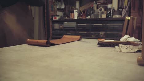 slider shot tanner hands polishing back of leather chair handcrafted in his workshop