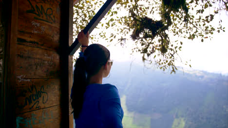 Woman-in-blue-clothes-staring-at-a-beautiful-landscape