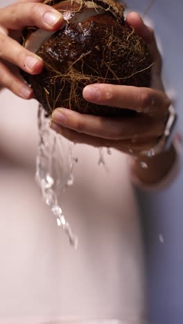 opening a coconut and pouring water