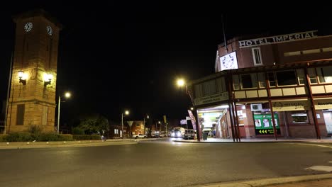 trucks and cars passing by a historic building