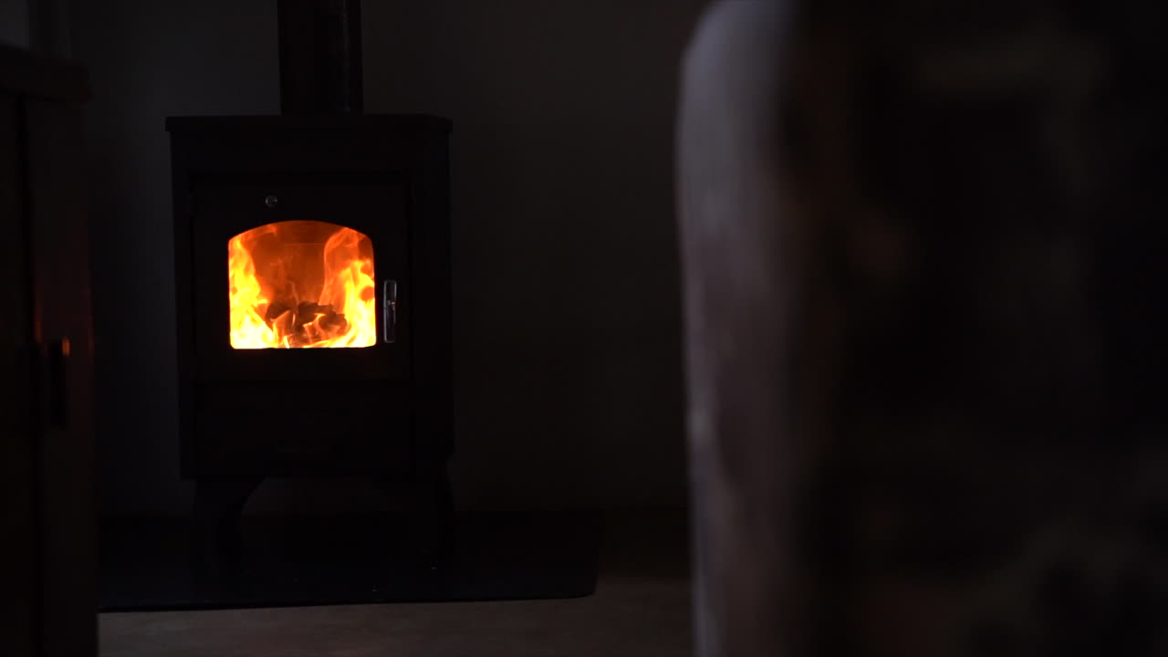 cinematic pan left to right Indoor fireplace burning wood fire