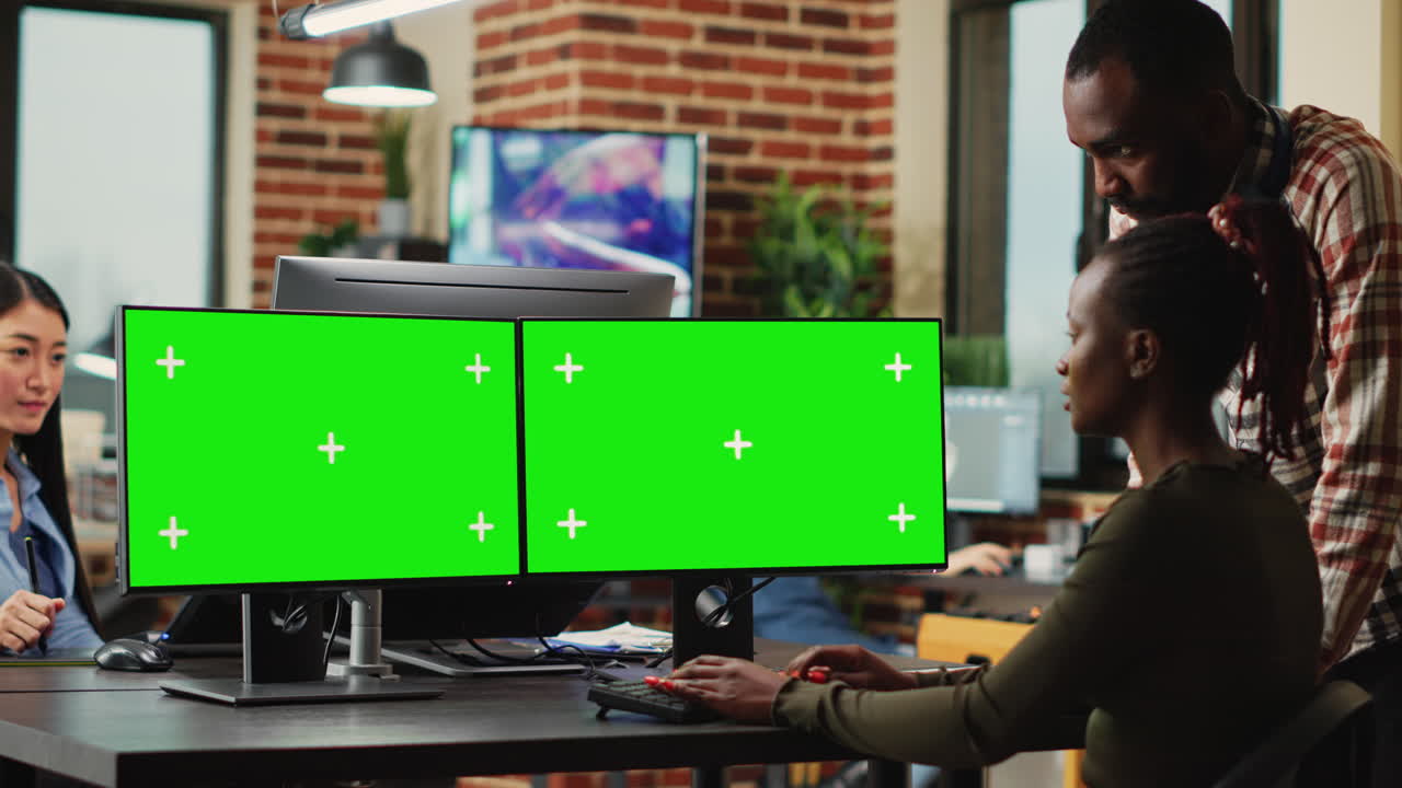 Digital company employees using greenscreen display on computers