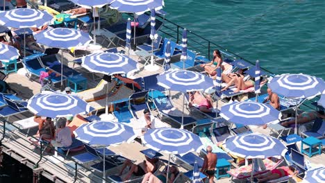 people enjoying sun and sea under umbrellas