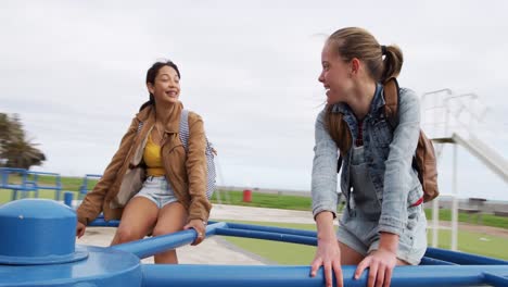 front view of a caucasian and a mixed race girl on a merry-go-round