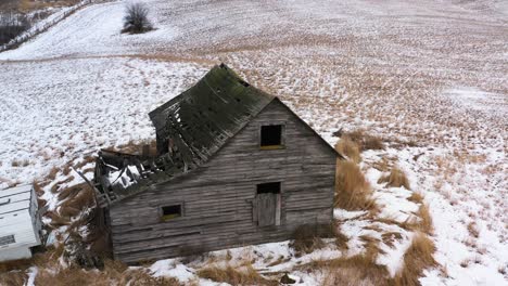 the silent beauty of neglect: a journey through the abandoned cabin's snowy landscape