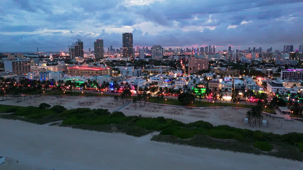 Drone shot of Miami Beach at dusk with neon lights