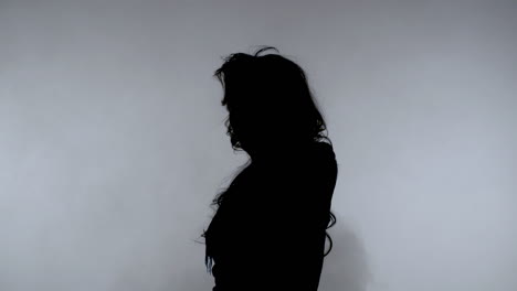 Woman-dark-silhouette-on-smoke-background.-Mysterious-girl-black-silhouette