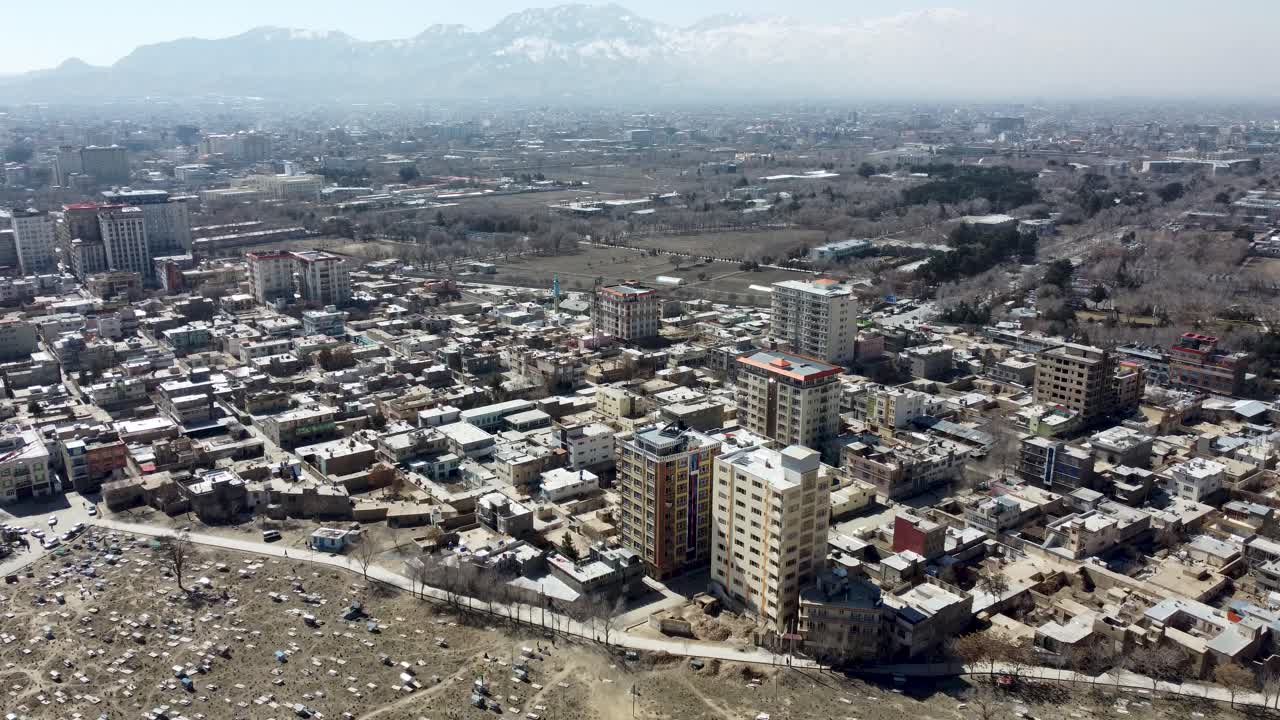 War struck Kabul, Afghanistan. Drone Shot of Sakhi Shrine Blue Mosque, Cemetery and Hillside Homes. Deaths of war