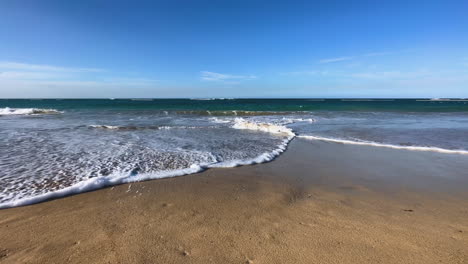 water-level-shot-of-the-ocean-waves-rolling-in-and-intersecting-as-they-retreat-back-into-the-Caribbean-sea-Dominican