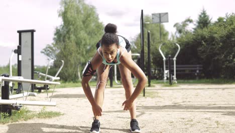 sportswoman warming up in park