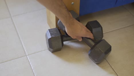 weights on floor - hands reach out to pick up but decide against it