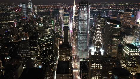 an aerial view shows the skyline of 42nd street in new york city new york at night highlighting the chrysler building