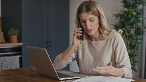 caucasian woman having financial difficulties and having phone call.