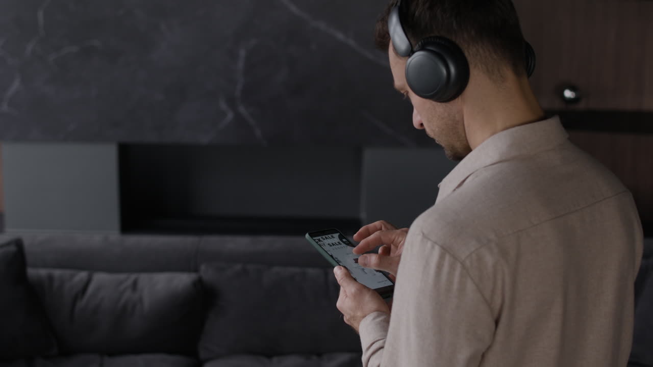Man using smartphone with headphones