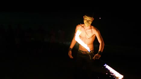 performer showcasing fire skills at night