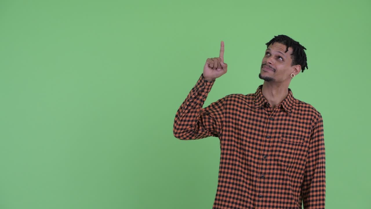 Happy young handsome African man with dreadlocks