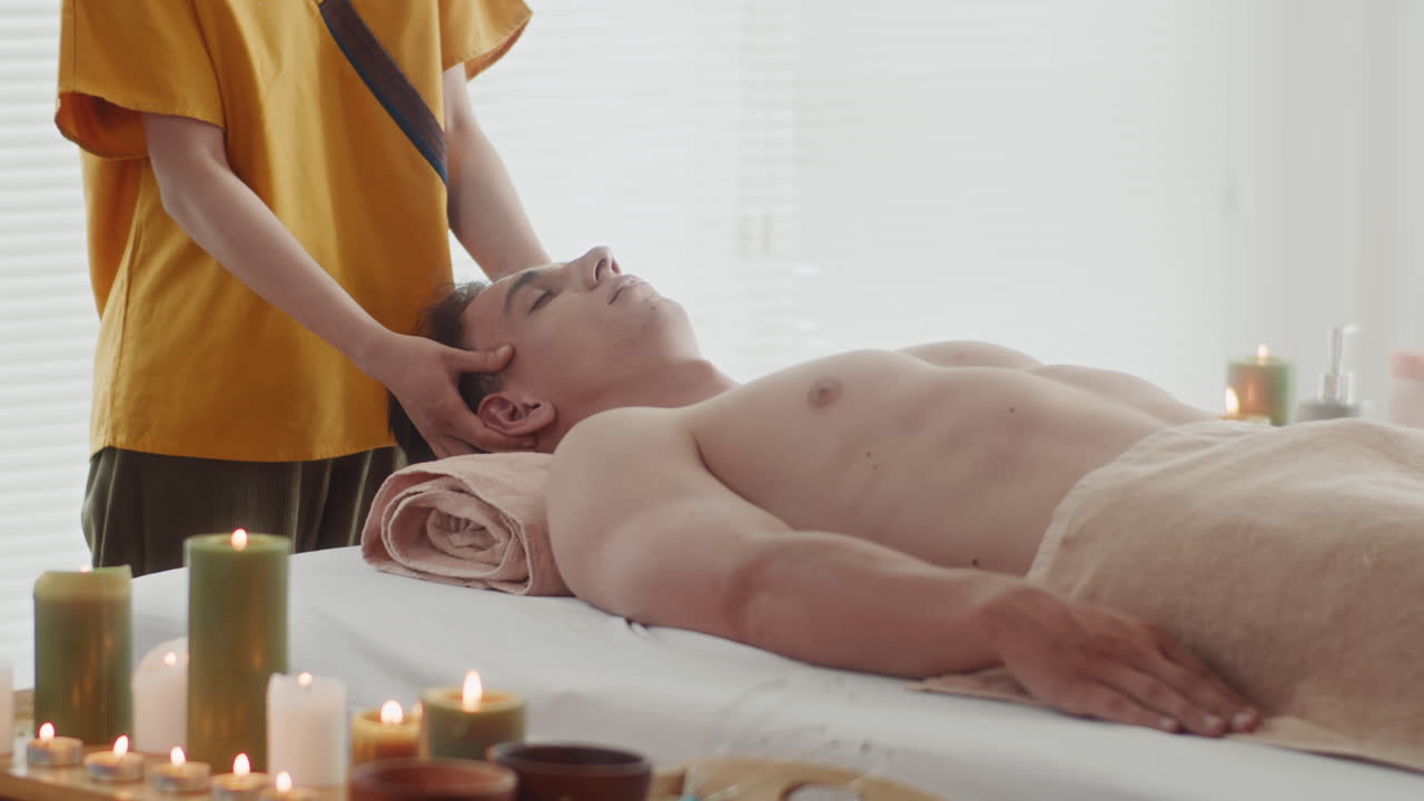 Woman Doing Face Massage to Client