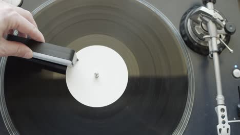 cleaning gramophone record with a dust brush for clean music listening - top-view