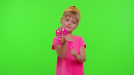 Girl-playing-spinning-with-pop-it-sensory-anti-stress-toy-in-park,-stress-anxiety-relief,-chroma-key