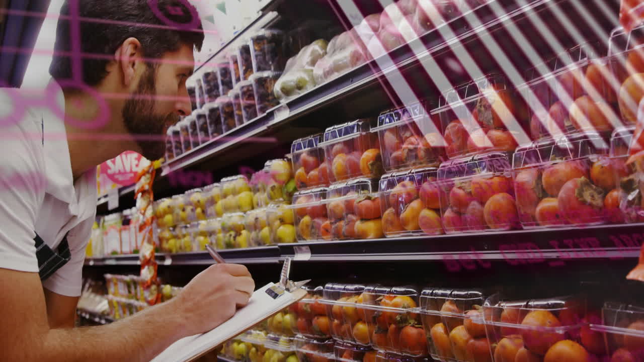 Checking inventory of packaged fruits, man working in supermarket aisle