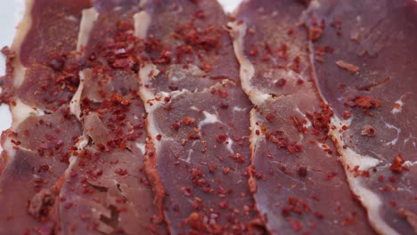 close up of sliced turkish bastırma with red pepper flakes