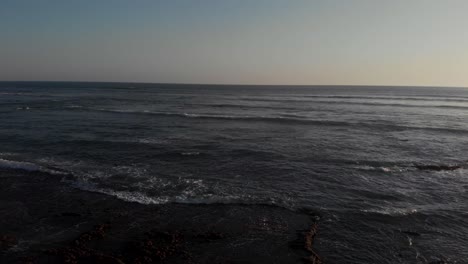 flying passed the rocky mountain shore of costa rica during sunset