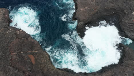 Atlantic-coast-on-Sal-Island,-Cape-Verde,-volcanic-stone-contrasting-with-the-Atlantic-Ocean